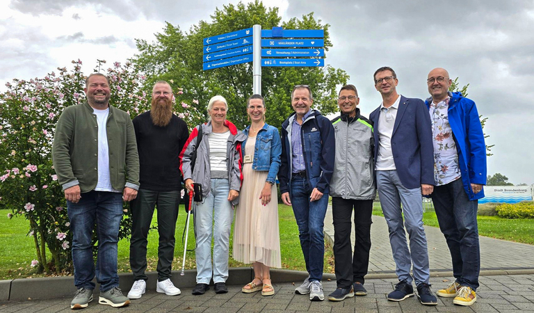 Mitglieder des Lions-Clubs um dessen Präsident Dr. med. Mathias Sprenger mit der Beigeordneten Alexandra Adel bei der Vorstellung des blindFind-Orientierungssystems auf der Regattastrecke Beetzsee. © Stadt Brandenburg an der Havel / Th. Messerschmidt