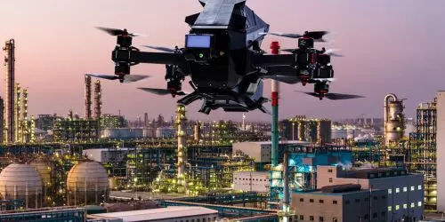 Drohne fliegt über Industrieanlage bei Dämmerung. Modellbild Foto: Heidelberger Druckmaschinen AG